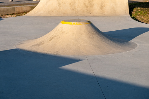 view of a ramp at a skatepark at sunset