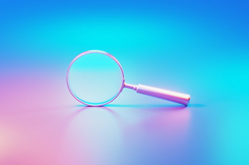 Metallic magnifier illuminated by blue and pink lights on blue and pink background. Horizontal composition with copy space.