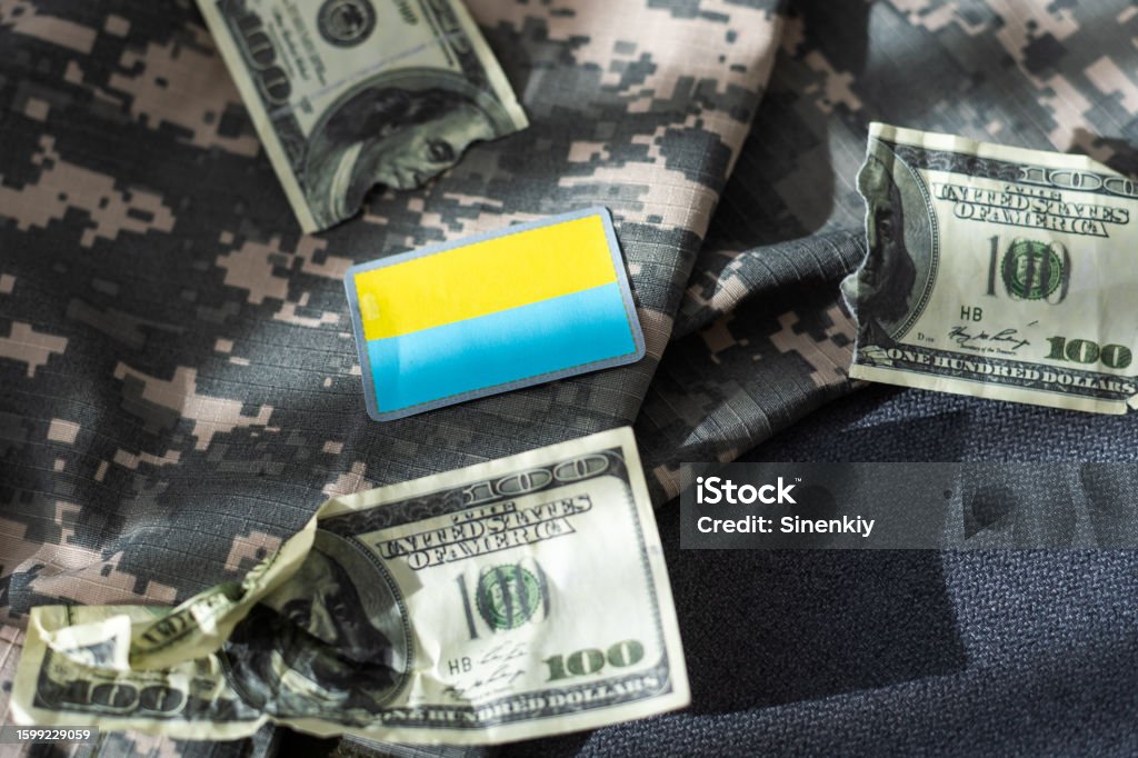 Military patch and bullets on pixel Ukrainian camouflage, closeup Military patch and bullets on pixel Ukrainian camouflage, closeup. High quality photo 2022 Stock Photo