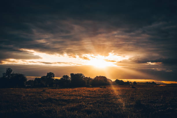 The sun behind the cloud. Rays of light from the sun.