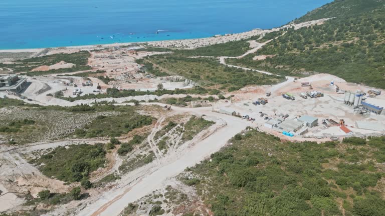 Aerial view of a large construction site with heavy machinery doing earthworks