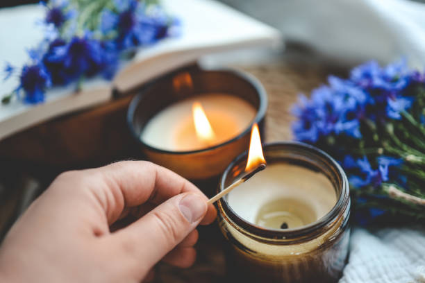 istock Match in hand lights a candle, aesthetic photo 1599260455