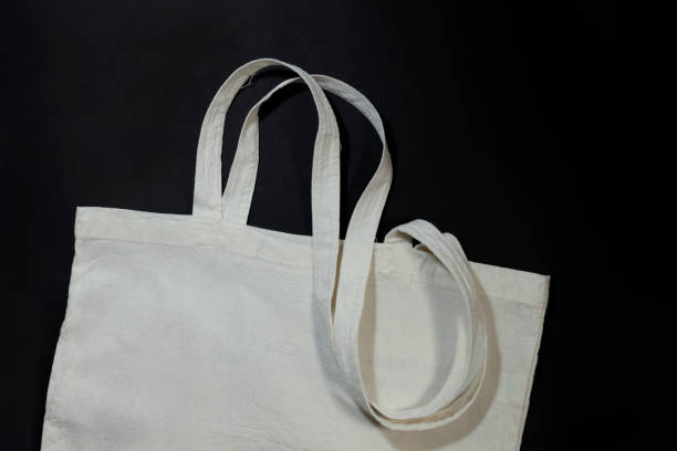 istock White cotton or mesh bag on black background. Zero waste, no plastic, eco friendly shopping, recycling concept. 1599260465