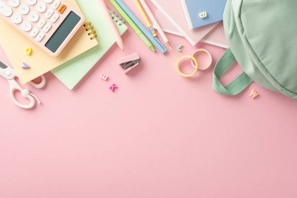 istock Girly elementary school tools layout. Top view of stylish sage backpack, pens, pencils, scissors, calculator, and other stationery arranged on pastel pink background with space for text or promotion 1599290928