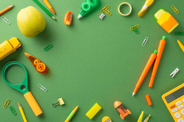 istock Dive into learning extravaganza with this top view. From colorful stationery, carrot pens, to mini bus toy, they all rest atop green board background with blank space perfect for text or advertising 1599293845