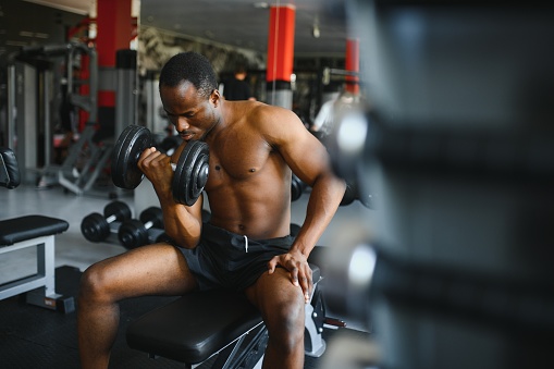 African American young man doing workout at the gym.