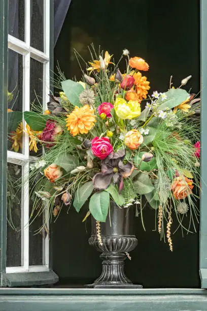 large bouquet of flowers in the open window