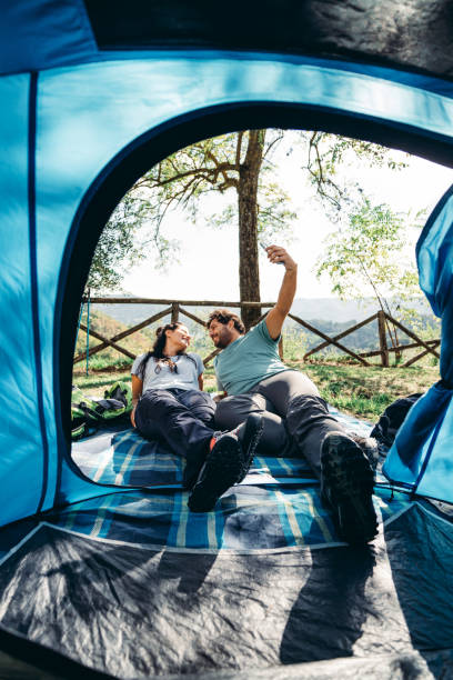 istock couple take a selfie inside the tent 1599337808