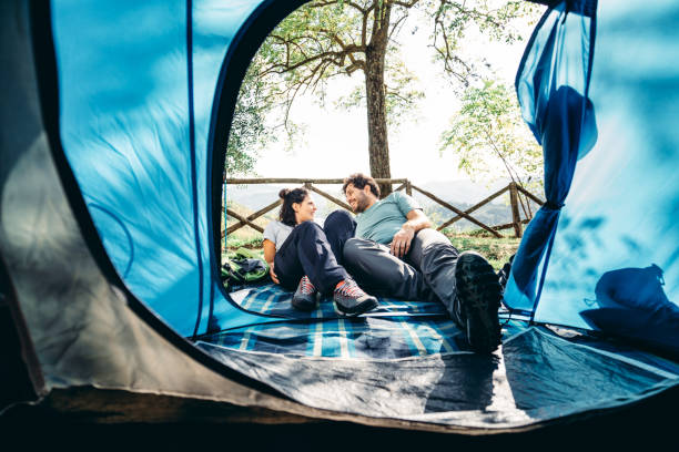 istock couple resting inside the tent 1599339359