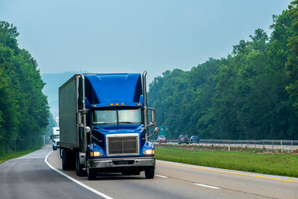 istock Blue Tractor-Trailer Rig Cruises An Interstate Highway 1599365926