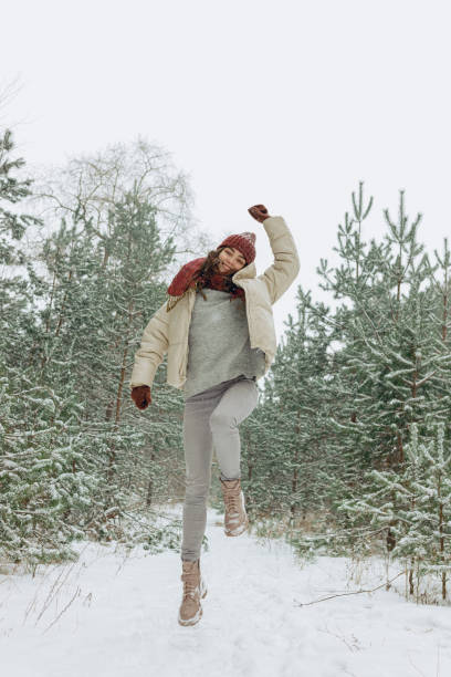 istock Joyful woman having fun in winter park 1599365928