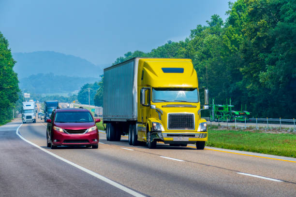 Yellow Tractor-Trailer Traveling On Tennessee Interstate Highway stock photo