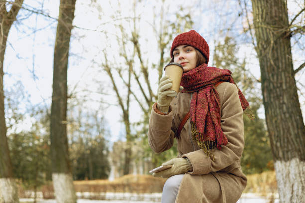 istock Woman drinking coffee in winter park 1599382855