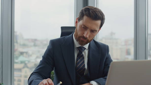 istock Accountant writing financial papers sitting at desk office closeup. Ceo thinking 1599434562