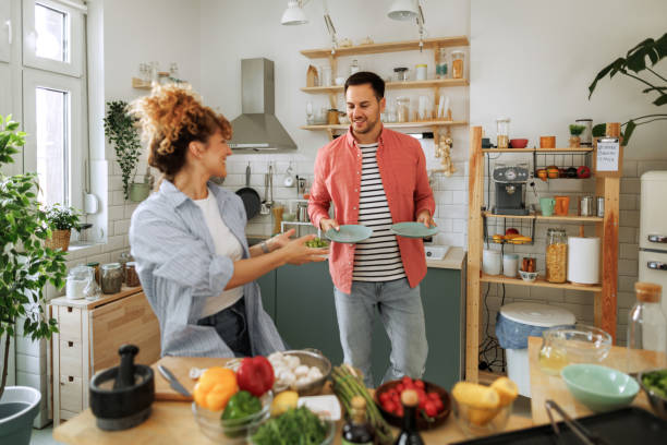 istock Young casually clothed couple making breakfast in a domestic kitchen 1599450644