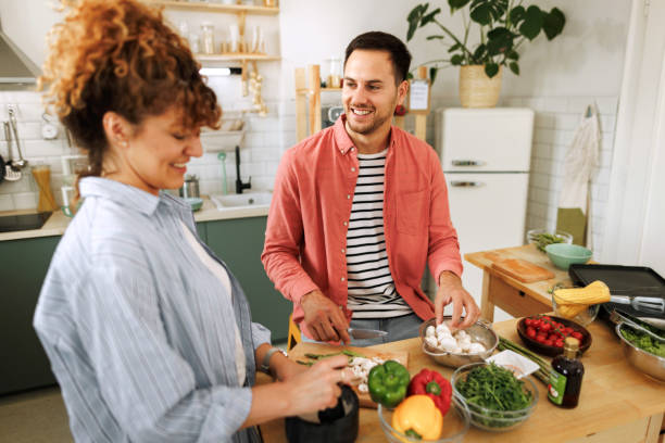 istock Young couple cooking together in a domestic kitchen 1599451191