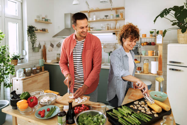 istock Young couple grilling vegetables in a domestic kitchen 1599451965