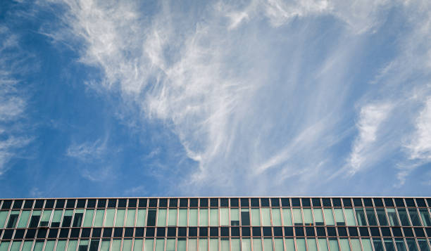 Low angle view of modern building against cloudy sky