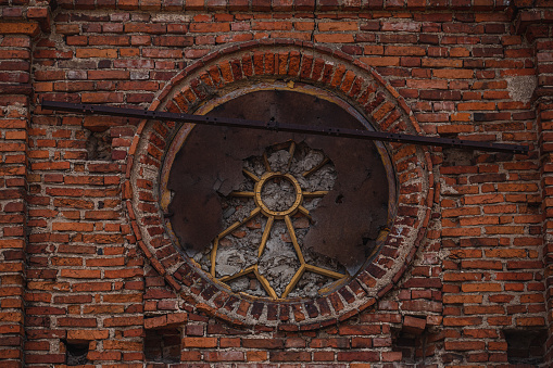 Clock on a brick wall. Ancient brick factory building and architecture of the city of Tampere, Finland.