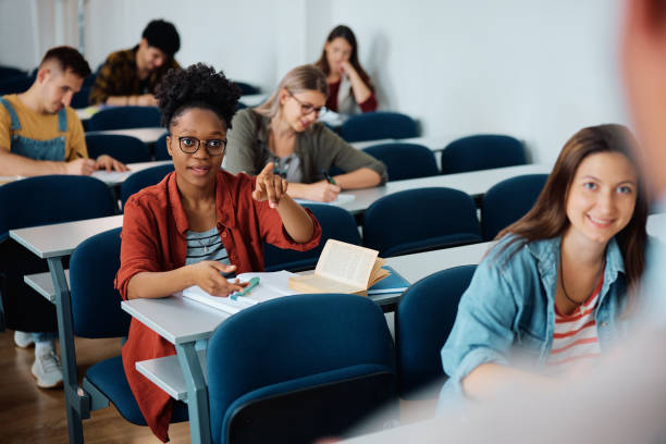 istock Black female student talking to a teacher during a class at university classroom. 1599476886