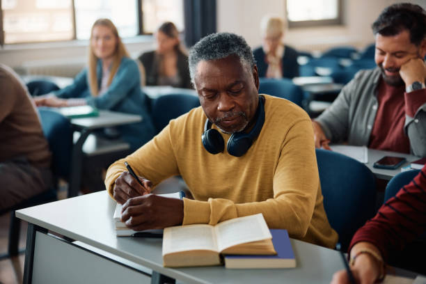 istock Black senior man learning while attending an educational course in the classroom. 1599477397