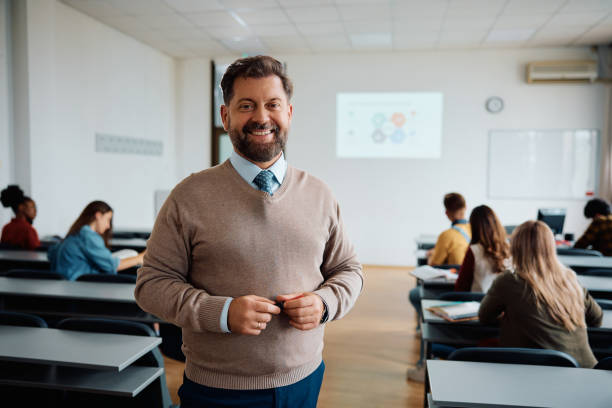 istock Happy university teacher in the classroom looking at camera. 1599477407