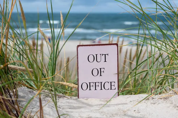 The slogan 'out of office' in the sand dunes at the beach. The slogan 'out of office' in the sand dunes at the beach.
