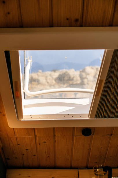 istock Interior of a camper van with a mountain view through the skylight window 1599503820