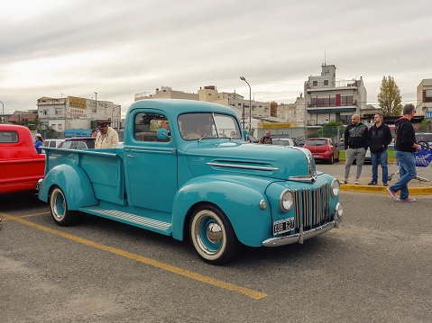 Buenos Aires, Argentina - Jun 4, 2023: old aqua 1940s Ford pickup truck in a parking lot. Classic car show