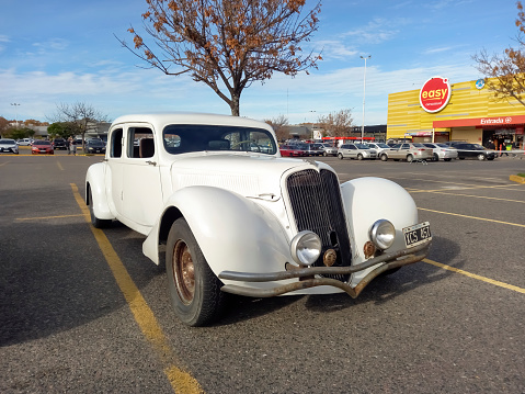 Buenos Aires, Argentina - Jun 4, 2023: Old white 1932 Panhard and Levassor Six coupe street rod in a parking lot. Classic car show. Sunny day