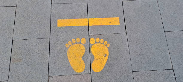 istock STAND HERE foot sign or symbol 1599559775