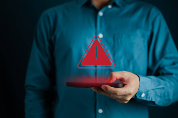 istock System warning hacked alert, cyber attack on computer network.Businessman using mobile phone with warning sign notification error, Malicious software,virus and cybercrime 1599585870