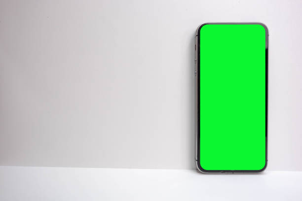 istock Mobile phone with green screen isolated on white background 1599629004