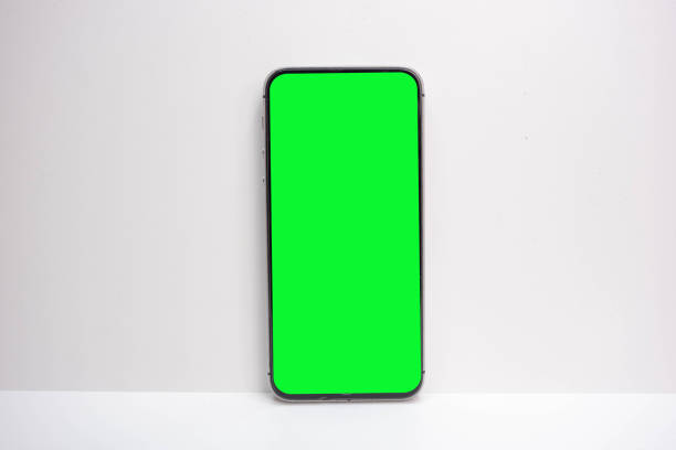 istock Mobile phone with green screen isolated on white background 1599630019