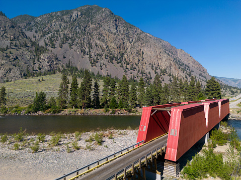 The Ashnola bridge across Similkameen River, was completed in 1907 and rebuilt in 1926 with its Howe trusses sheathed in wood panelling and cross-bracing exposed overhead. It is found in Keremeos, British Columbia, Canada.