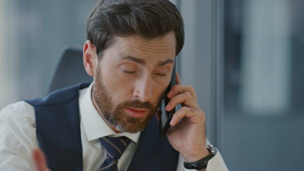 istock Director discussing work phone in office close up. Manager talking on smartphone 1599659682