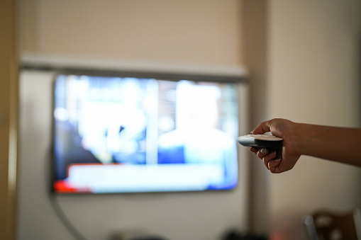 woman using tv remote