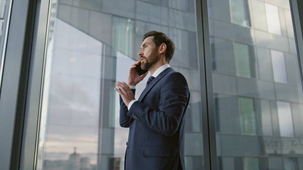 istock Portrait boss speaking smartphone in office. Businessman using telephone closeup 1599682952