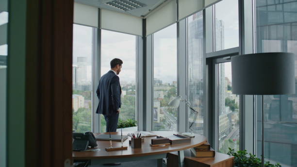 istock Entrepreneur looking office window. Smart businessman thinking business ideas. 1599705140