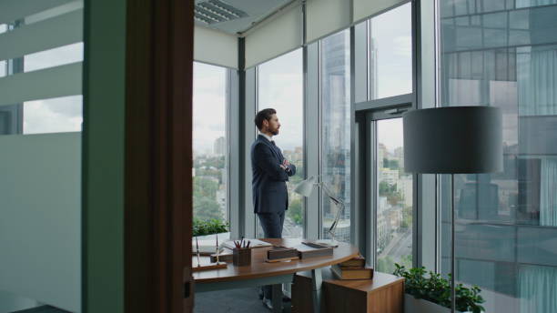 istock Lawyer thinking work office in elegant suit. Manager taking break looking window 1599706175