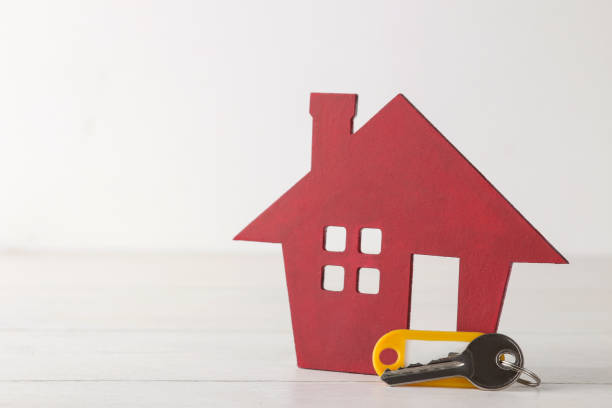 istock Home purchase concept. Small decorative house and keys on a white background 1599723584