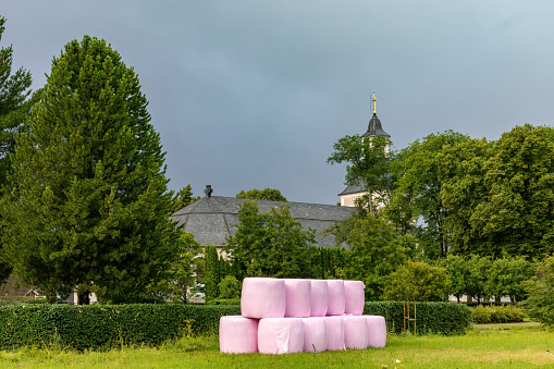 Leksand, Sweden A view of the Insjon Church and hay bales in pink.