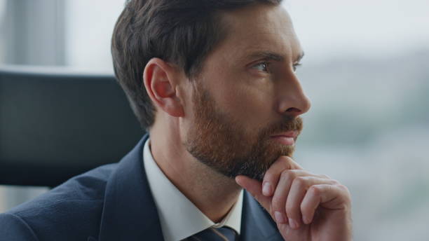 istock Focused entrepreneur thinking business opportunity sitting office close up. 1599726741