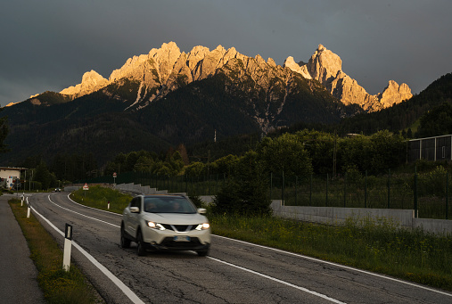 Beautiful natural phenomenon with stormy clounds and a sunshine over mountain peaks.