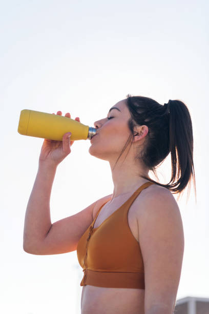 istock thirsty and tired runner drinking water outdoors 1599728922