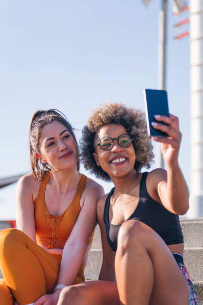 istock two runner friends taking selfie with mobile phone 1599728945