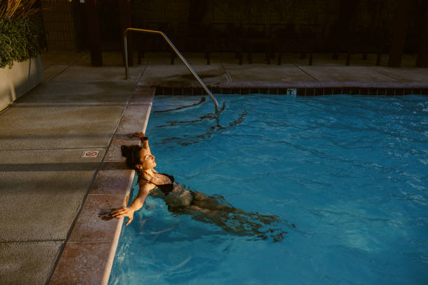 Woman relaxing in the pool, spending an easy afternoon.