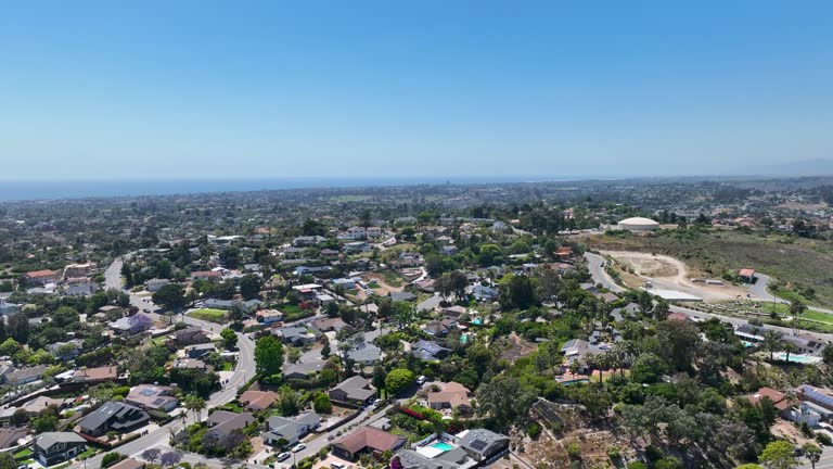Drone shot aerial flyover over streets and neighborhood houses in Oceanside California