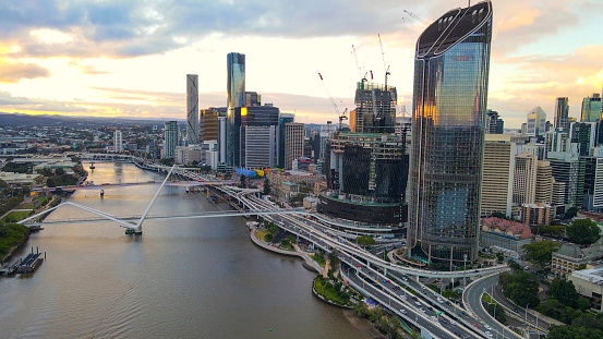 Aerial drone view of Brisbane City, QLD, Australia looking toward the west facing side of the city along Brisbane River and Riverside Expressway during late afternoon in August 2023
