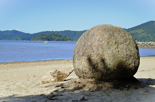 A round rock on the Pontal beach in Paraty in Rio de Janeiro on a sunny day